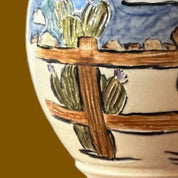 Ceramic vase with a scenic design on a brown background